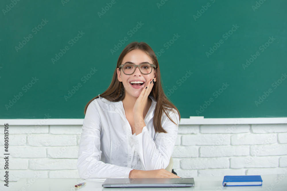 Student preparing exam and learning lessons in school classroom. Happy amazed school girl. Student preparing exam and learning lessons in school classroom. Happy amazed school girl.