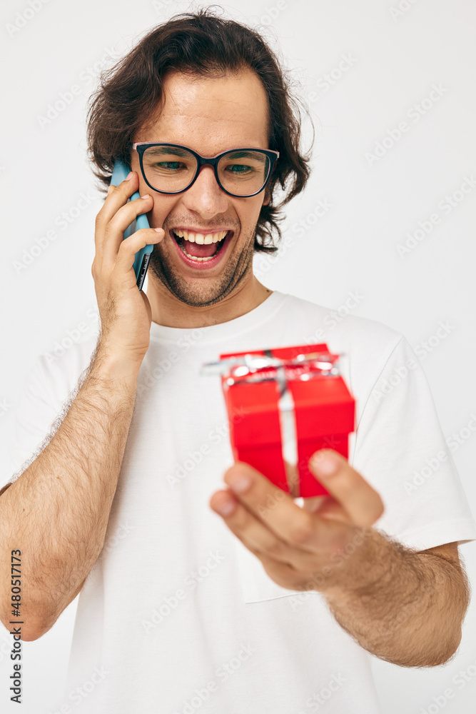 Attractive man talking on the phone gift box isolated background Attractive man talking on the phone gift box isolated background