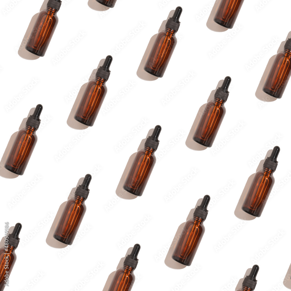 Seamless pattern of anti aging serum in glass bottle with dropper on white background. Creative layout, cosmetic seamless pattern, flat lay. Creative cosmetics pattern background Seamless pattern of anti aging serum in glass bottle with dropper on white background. Creative layout, cosmetic seamless pattern, flat lay. Creative cosmetics pattern background