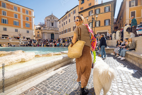 Photography Woman with dog on famous di Trevi fountain in Rome