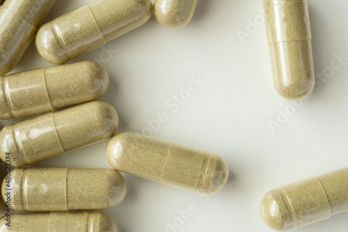 Herbal medicine capsules on white background