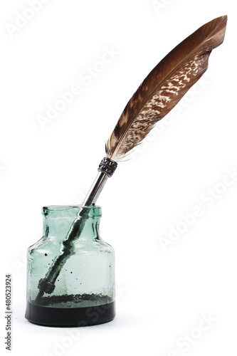 Feather in an inkwell. Quill pen and bottle of ink