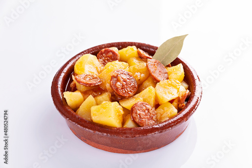 Potatoes stew with chorizo, patatas a la riojana, on white background 