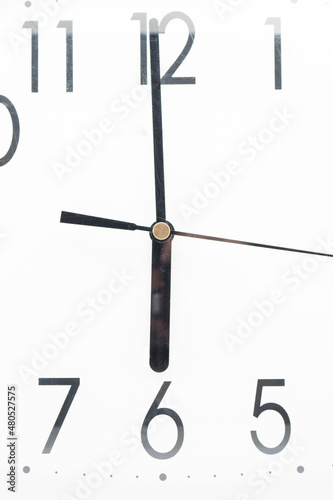 Black classic clock on isolated white background.