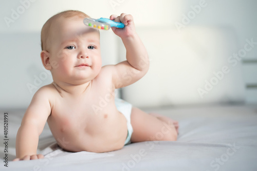 Six month boy sits on the white background