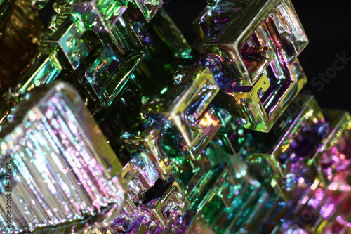Synthetic bismuth (Bismuthum) crystal with rainbow oxide film close up, fantastic abstract background