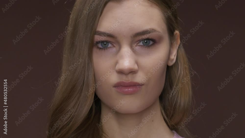 the young woman wrinkles her face with contempt and disgust the young woman wrinkles her face with contempt and disgust