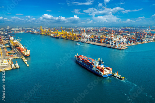 Aerial view of cargo ship and cargo container in harbor.