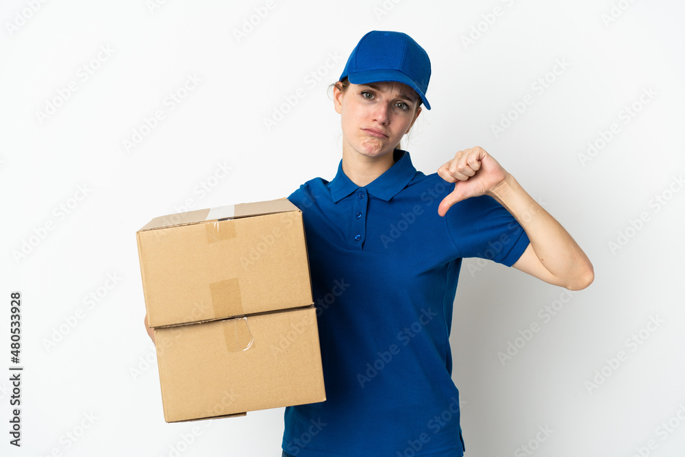 Young delivery woman isolated on white background showing thumb down with negative expression