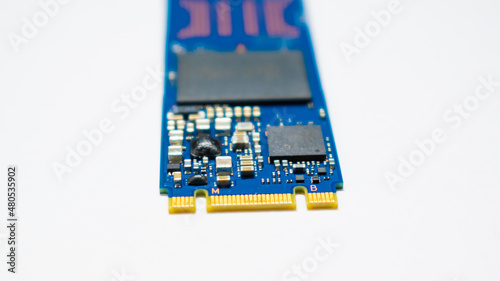 SSD hard drive NVMe version for slot M.2 laid on white background and narrow focus at pinout photo