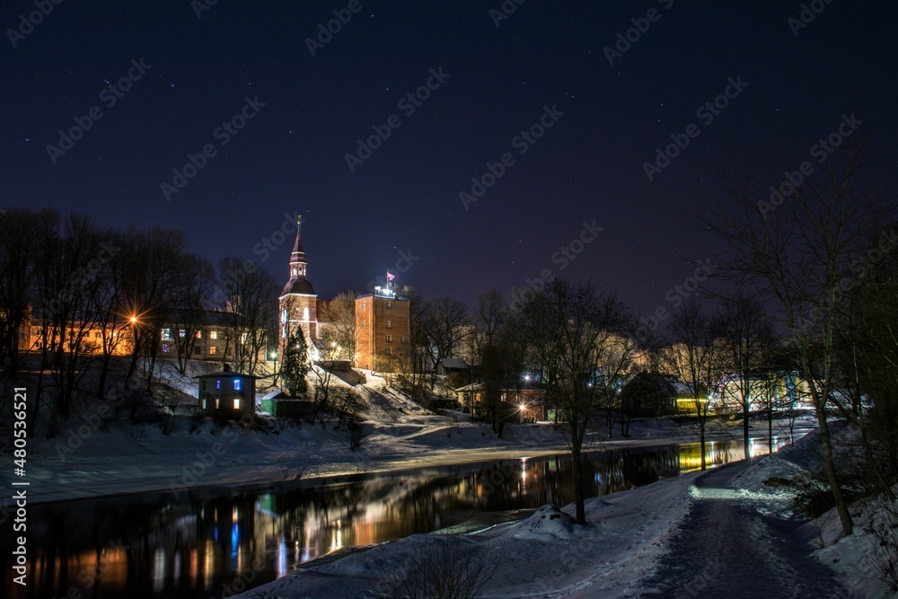 Old town and river on a winter night. Valmiera, Latvia.