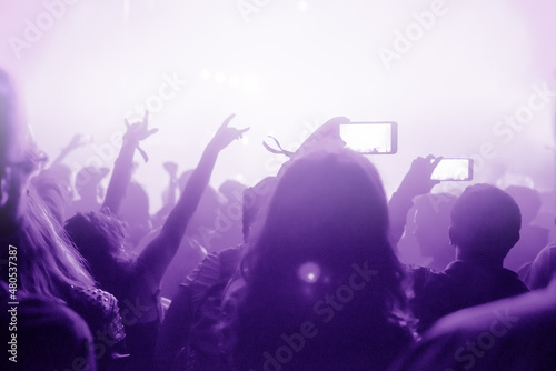Fototapeta Naklejka Na Ścianę i Meble -  Raised arms holding smart phones to recording a live concert