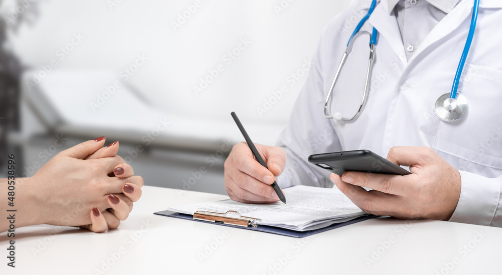Doctors and patients sit and talk to the patient about medication. Doctor and patient discussing medical problems in a hospital consulting room. Faceless view Doctors and patients sit and talk to the patient about medication. Doctor and patient discussing medical problems in a hospital consulting room. Faceless view