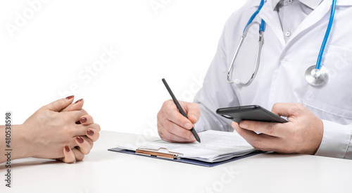 Patient and doctor taking notes. Doctor prescribing medication for patient. Unknown man doctor and female patient sitting and talking at medical examination in clinic. isolated on white.