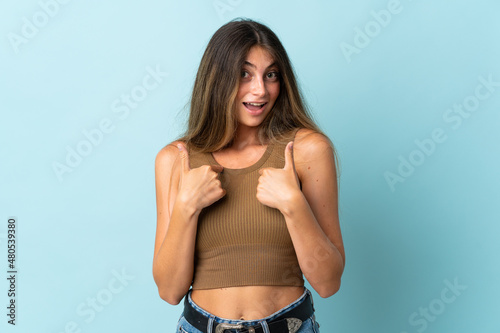 Young caucasian woman isolated on blue background with surprise facial expression © luismolinero