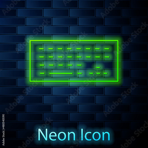 Glowing neon Computer keyboard icon isolated on brick wall background. PC component sign. Vector