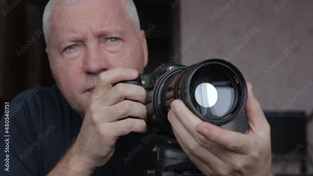 Photograper take a focus on beyond object with long focus lens. Photograper take a focus on beyond object with long focus lens.