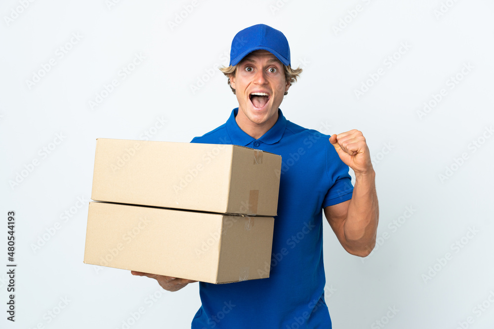 Delivery man over isolated white background celebrating a victory in winner position Delivery man over isolated white background celebrating a victory in winner position