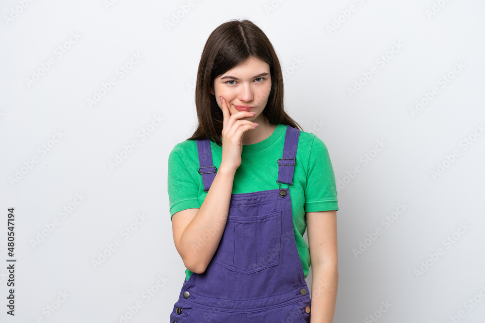 Young Russian woman isolated on blue background and thinking Young Russian woman isolated on blue background and thinking