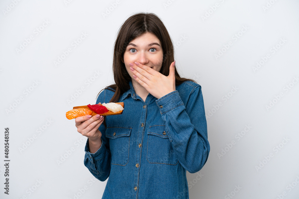 Young Russian woman holding sashimi isolated on white background happy and smiling covering mouth with hand Young Russian woman holding sashimi isolated on white background happy and smiling covering mouth with hand