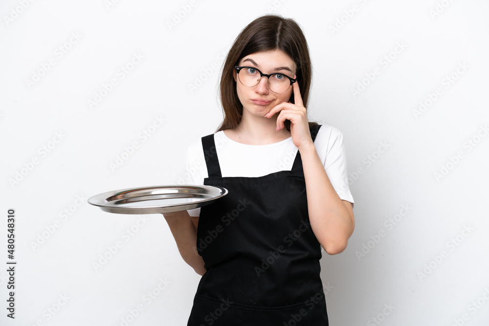 Young Russian woman chef with tray isolated on white background thinking an idea Young Russian woman chef with tray isolated on white background thinking an idea
