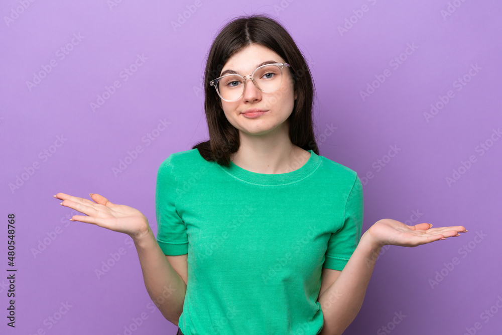 Young pretty Russian woman isolated on purple background With glasses and having doubts Young pretty Russian woman isolated on purple background With glasses and having doubts