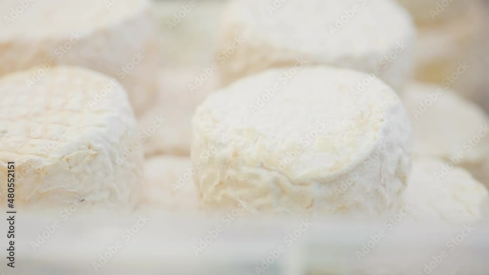Camembert cheese on the counter. Camembert brie cheese in a transparent container. Dairy product sales concept Camembert cheese on the counter. Camembert brie cheese in a transparent container. Dairy product sales concept