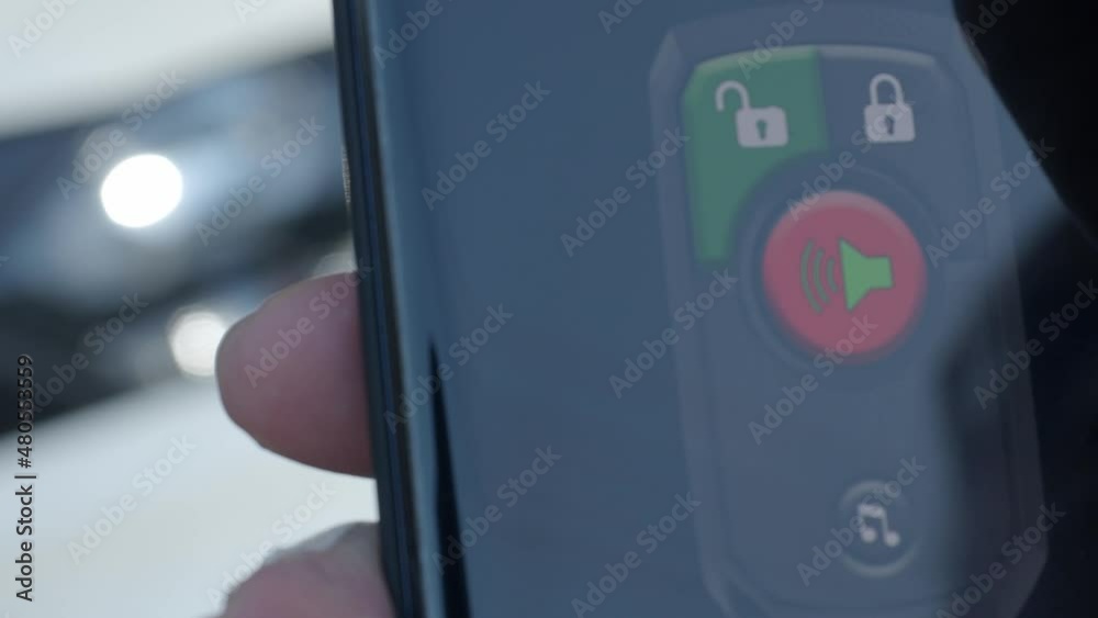 Unlock and lock Car Using Smartphone App. Man hand Unlocking car by use