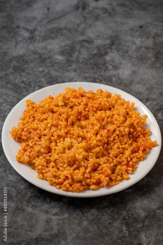 Bulgur pilaf on a dark background. Close-up of Turkish food Bulgur Pilav in a ceramic plate Bulgur pilaf on a dark background. Close-up of Turkish food Bulgur Pilav in a ceramic plate