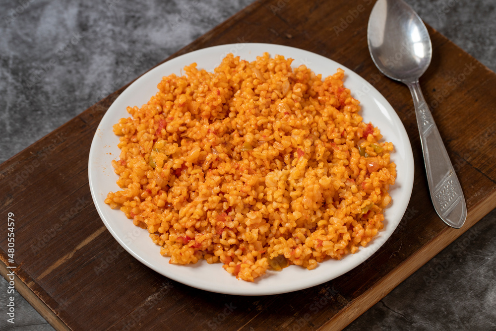 Bulgur pilaf on a dark background. Close-up of Turkish food Bulgur Pilav in a ceramic plate Bulgur pilaf on a dark background. Close-up of Turkish food Bulgur Pilav in a ceramic plate
