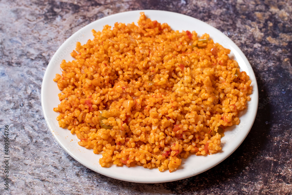Bulgur pilaf on a dark background. Close-up of Turkish food Bulgur Pilav in a ceramic plate Bulgur pilaf on a dark background. Close-up of Turkish food Bulgur Pilav in a ceramic plate