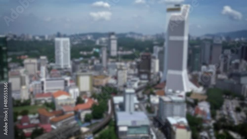 Blurred defocused an elevated view of train moving to station at Kuala Lumpur city in exterior day. Aerial view of metro in Malaysia. Subway city commute. Traveling in Asia. photo