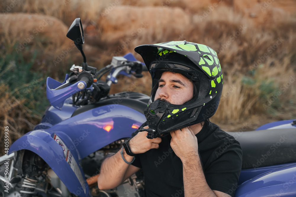 motorcyclist putting on the helmet