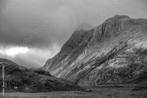Black and white Stunning landscape of dramatic sunrise light over Blea Tarn in Lake District with stunning light