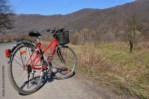 Red bicycle with mountain background
