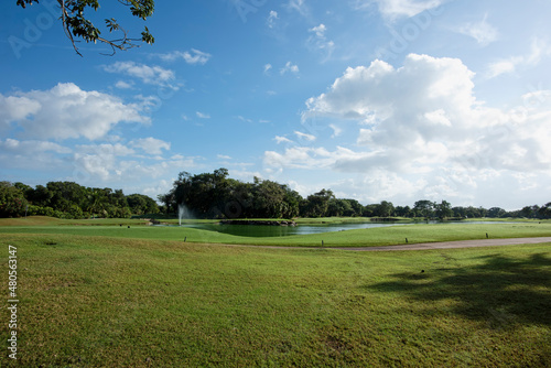Panoramic view of a golf course in Mexico with artificial lake in summer