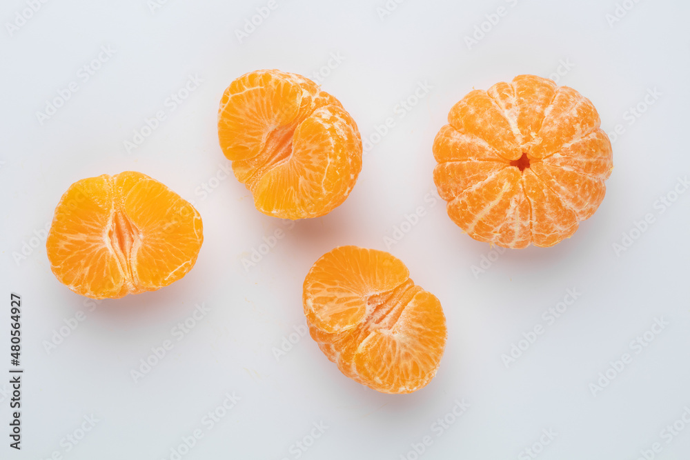 Ripe mandarines close-up on a white background. Tangerines on a white background. Ripe mandarines close-up on a white background. Tangerines on a white background.