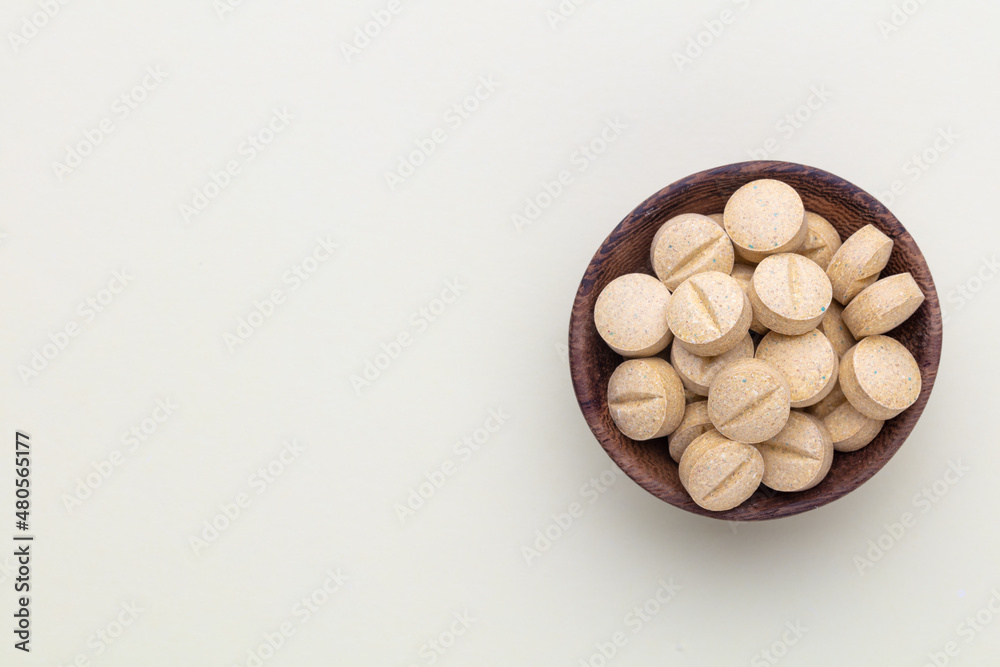 Alternative medicine tablets on a wooden spoon. Alternative medicine tablets on a wooden spoon.