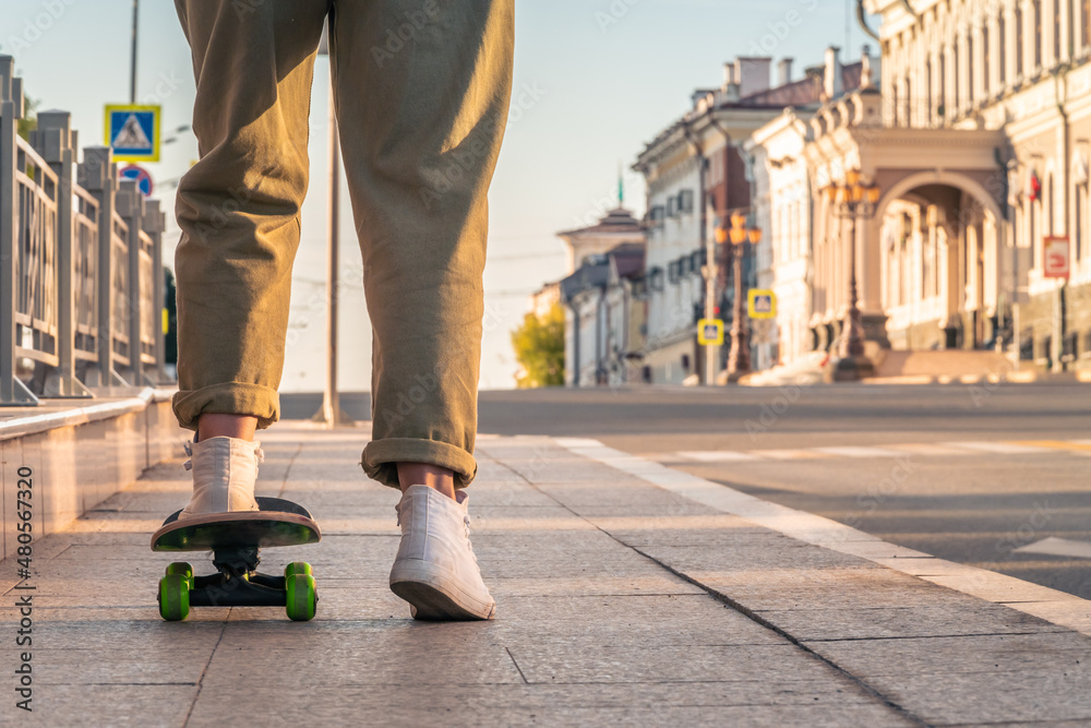 Close-up of a woman's legs on a skateboard