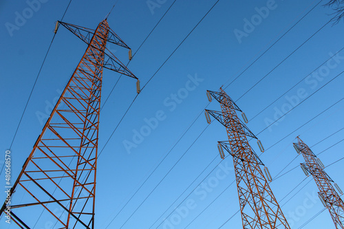 Tralicci e cavi alta tensione con sfondo cielo azzurro photo