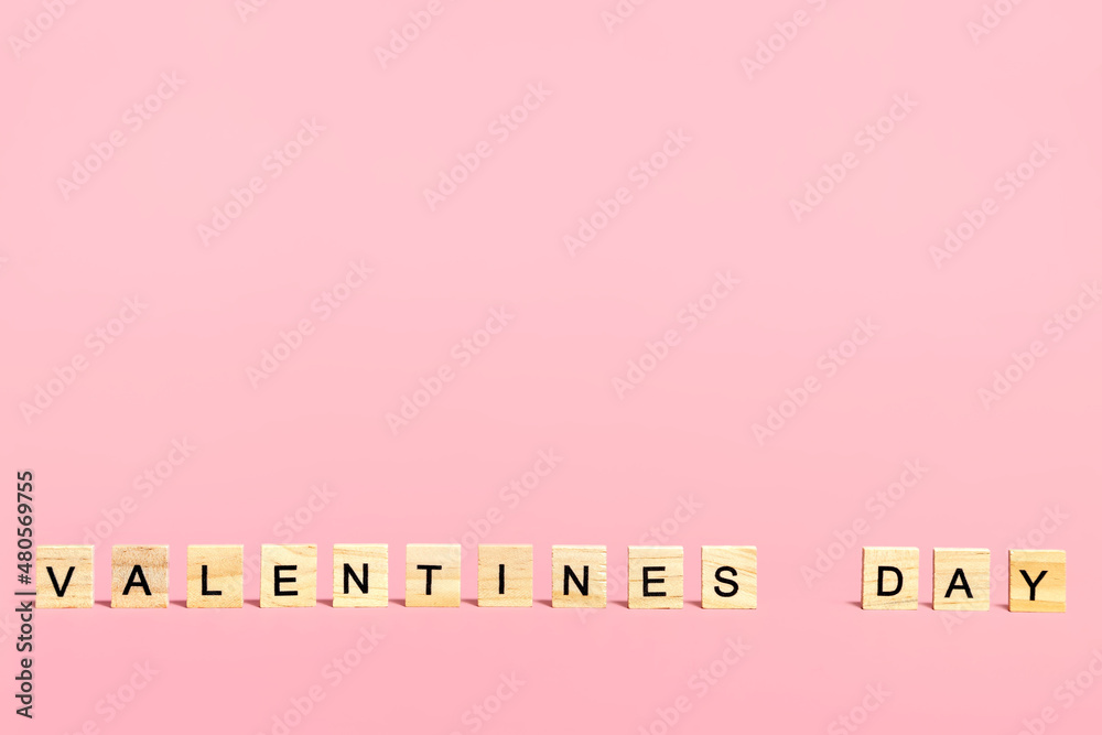 Obraz na płótnie Inscription Valentine's Day in wooden letters on a pink background.  w salonie