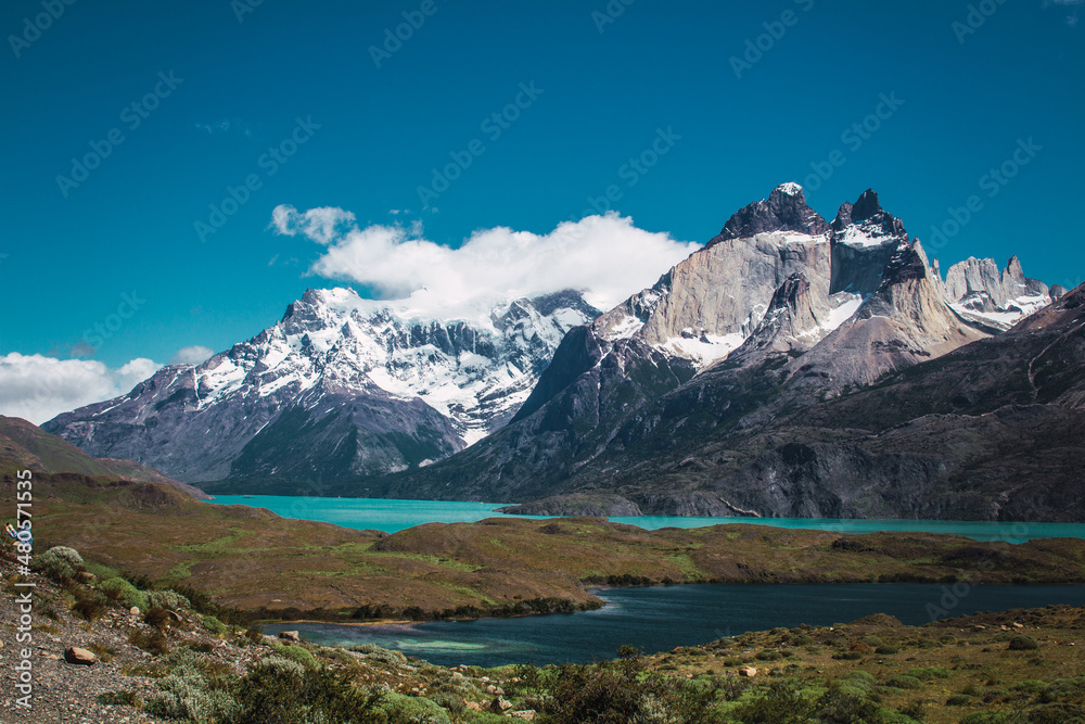 Snowy mountains with clouds on top in the Torres del Paine area of ​​Chilean Patagonia
