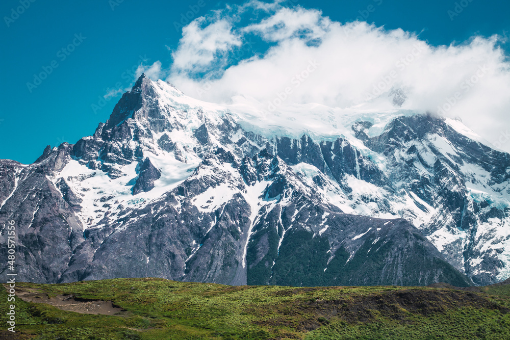 Snowy mountain tops with clouds in Chilean Patagonia