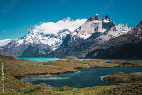 Fototapeta Naklejka Na Ścianę i Meble -  Snowy mountains with clouds on top with lakes in front in the Torres del Paine area of ​​Chilean Patagonia

