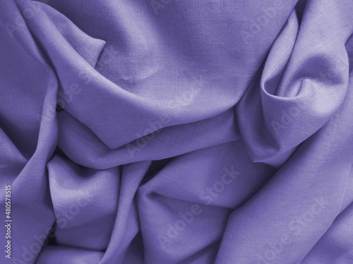 Violet natural linen fabric. Woven texture background. Very peri color textile drapery for sewing, fashion and cloth. Cotton and linen textile surface. Trendy color draped background. Color of year.