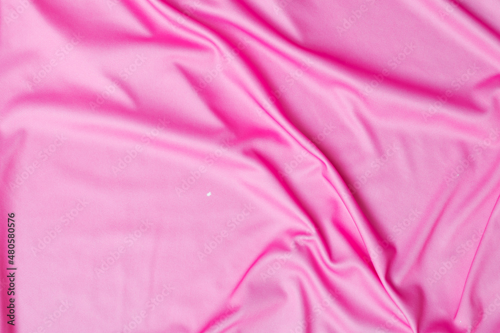 Obraz premium Closeup rippled soft pink fabric texture background