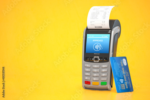 Fototapeta POS point of sale terminal for credit card payment on yellow background