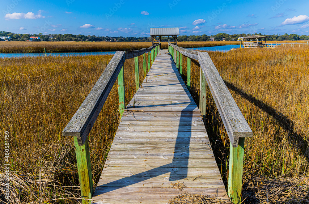Fototapeta premium Long Wooden Bridge Over The Salt Marsh of The Waccamaw River, Pawleys Island, South Carolina, USA