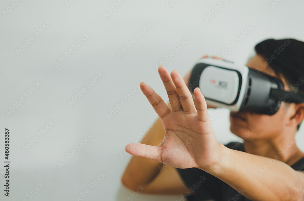 Fototapeta premium Virtual Experience. Excited Wearing VR Headset, Touching Air While Playing Video Game, Copy Space