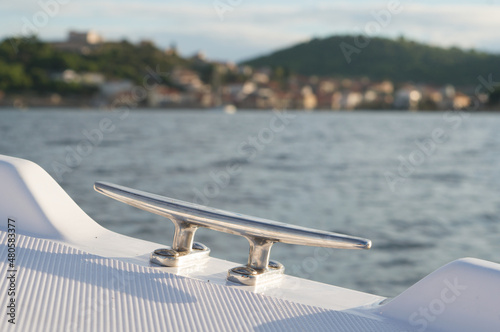 Fotografie Steel mooring cleat on the small plastic pleasure boat, nautical equipment, Adri